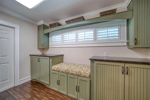 a kitchen with a wooden floor and cabinets