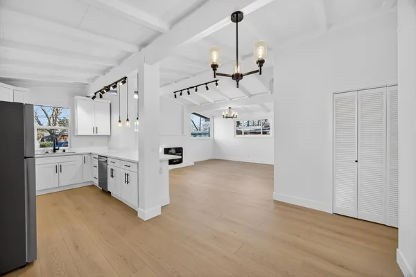a kitchen with cabinets stainless steel appliances and a counter space