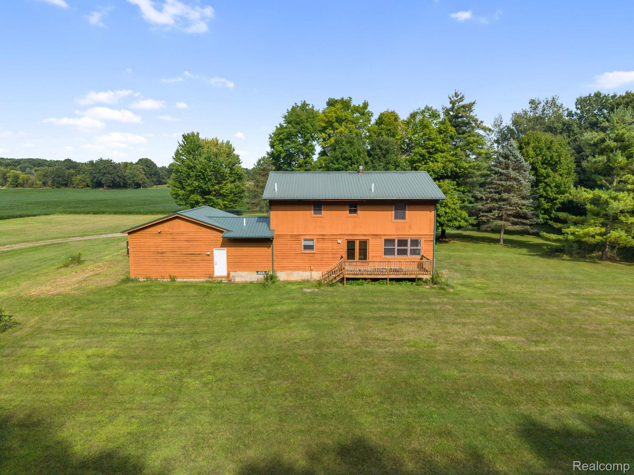 76565 McFadden Road Armada, MI 48005 - Photo 67 of 95 Wood-sided two-story residence with a metal roof and an attached single-story structure