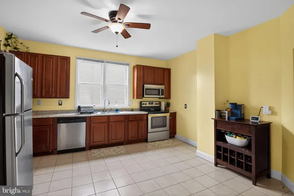 a kitchen with stainless steel appliances granite countertop a refrigerator and a stove top oven