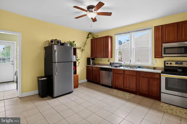 a kitchen with stainless steel appliances granite countertop a refrigerator a stove a sink dishwasher and a refrigerator