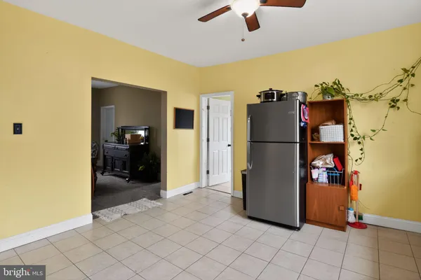a view of a livingroom with furniture and a refrigerator