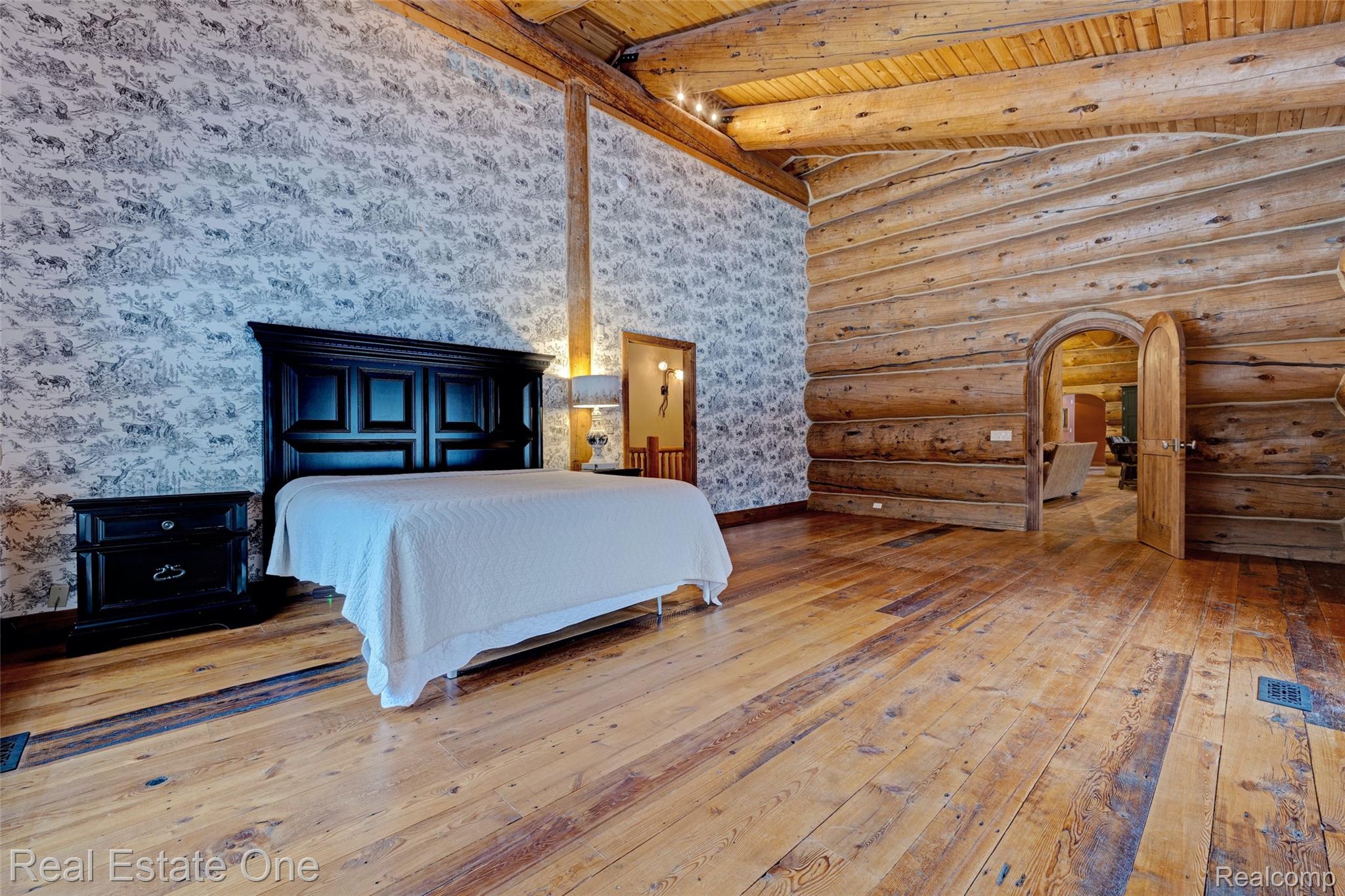 4340 Lahring Road Holly, MI 48442 - Photo 19 of 89 Bedroom featuring light wood finished floors, log walls, and a wood ceiling with exposed beams