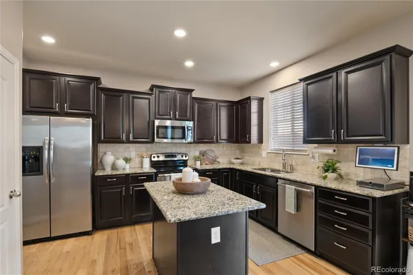 a kitchen with a sink stainless steel appliances and cabinets