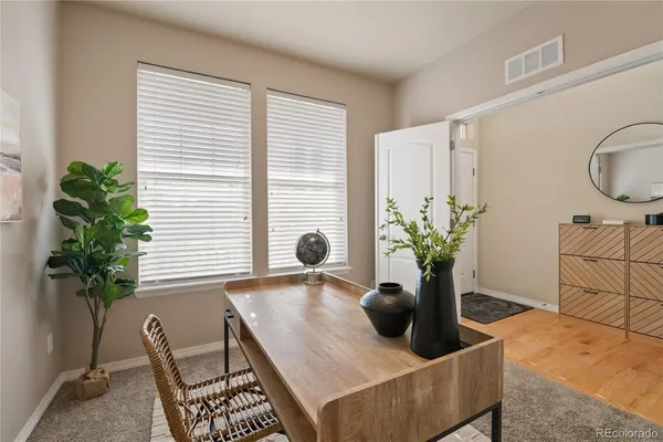 a living room with furniture and potted plant