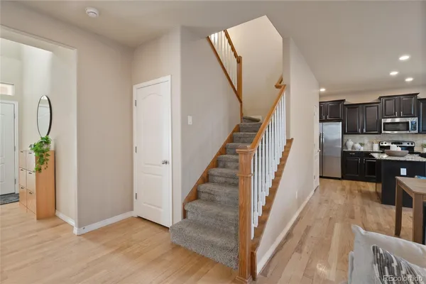 a view of a kitchen with furniture and wooden floor