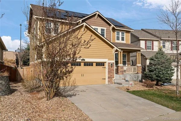 a view of a house with a yard and garage