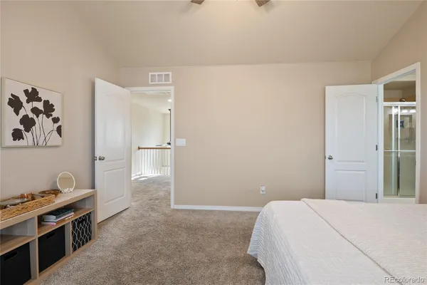 a bedroom with a bed and a view of kitchen