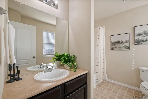 a bathroom with a sink toilet and mirror