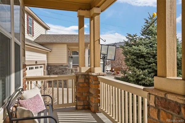 a view of a balcony with chair and wooden floor