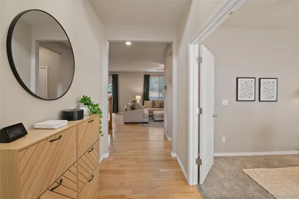 a living room with furniture and a mirror