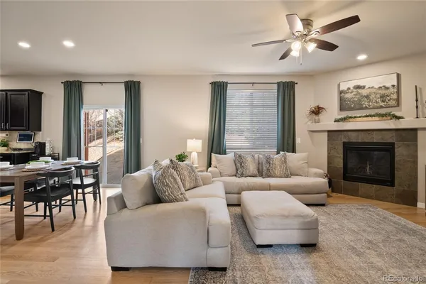 a living room with furniture a fireplace and a flat screen tv