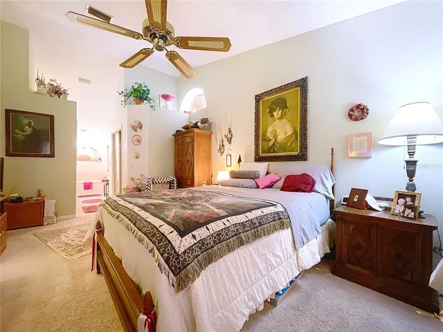 a bedroom with bed and a chandelier