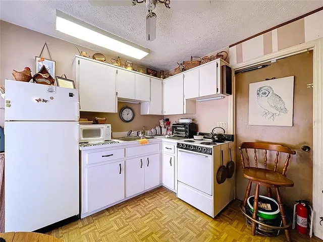 a view of a dining room with furniture a chandelier and window