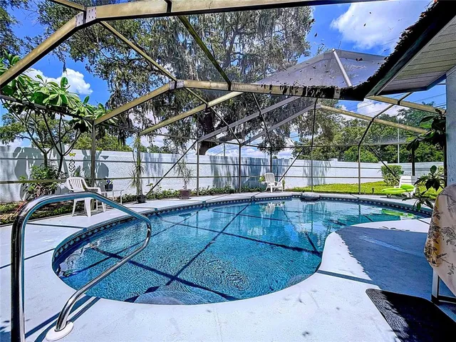 a view of a swimming pool with a patio