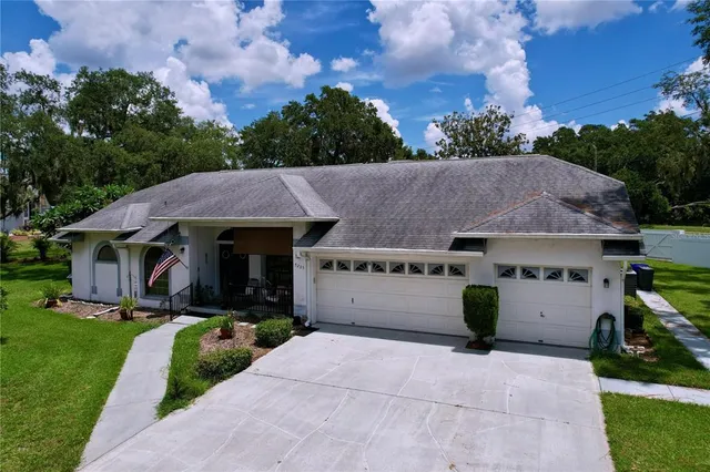 a aerial view of a house with yard and a garden