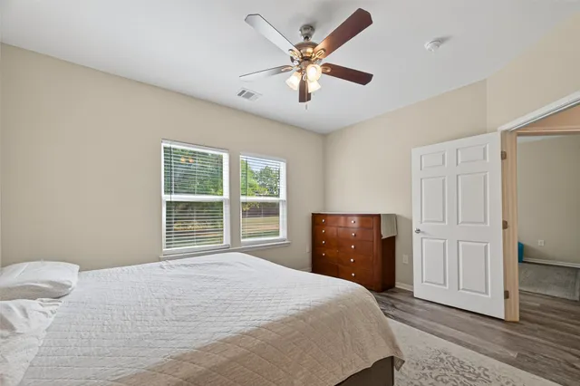 a bedroom with a large bed and a window