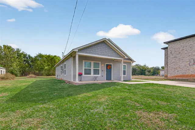 a front view of house with yard and green space