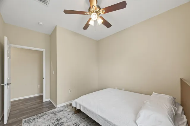 a bedroom with a bed and a ceiling fan