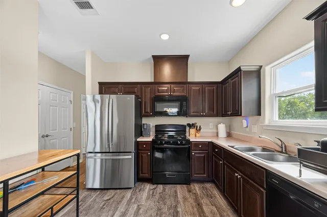 a kitchen with a refrigerator stove and sink