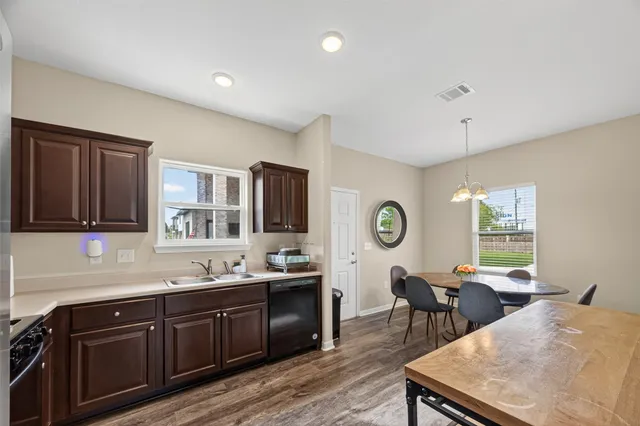 a view of a kitchen with a dining table and chairs