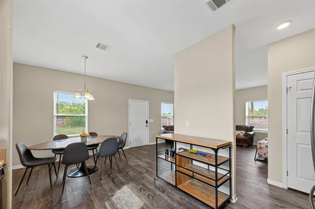 a living room with furniture a window and wooden floor