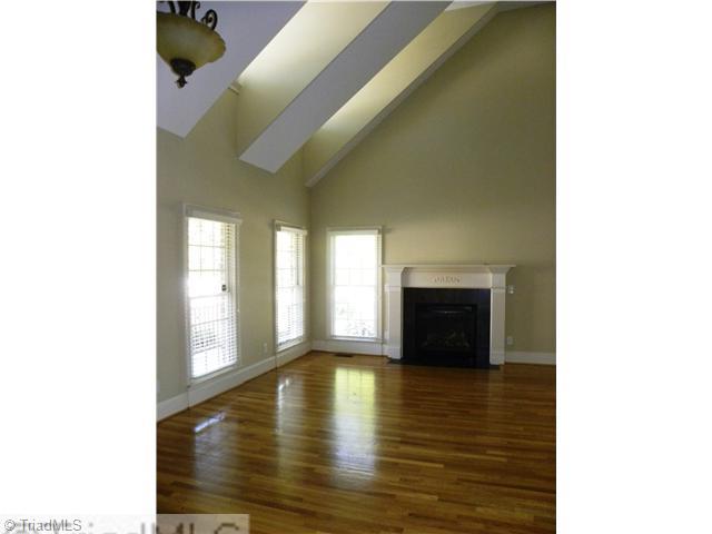 5909 A Ballinger Road Greensboro, NC 27410 - Photo 2 of 5 Den/Family/Great Room. Vaulted Great Room with hardwoods and fireplace. Opens to Dining Room with hardwoods.
