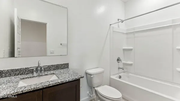 a kitchen with stainless steel appliances kitchen island granite countertop a refrigerator stove top oven and sink