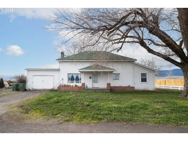 a house view with a sitting space and garden