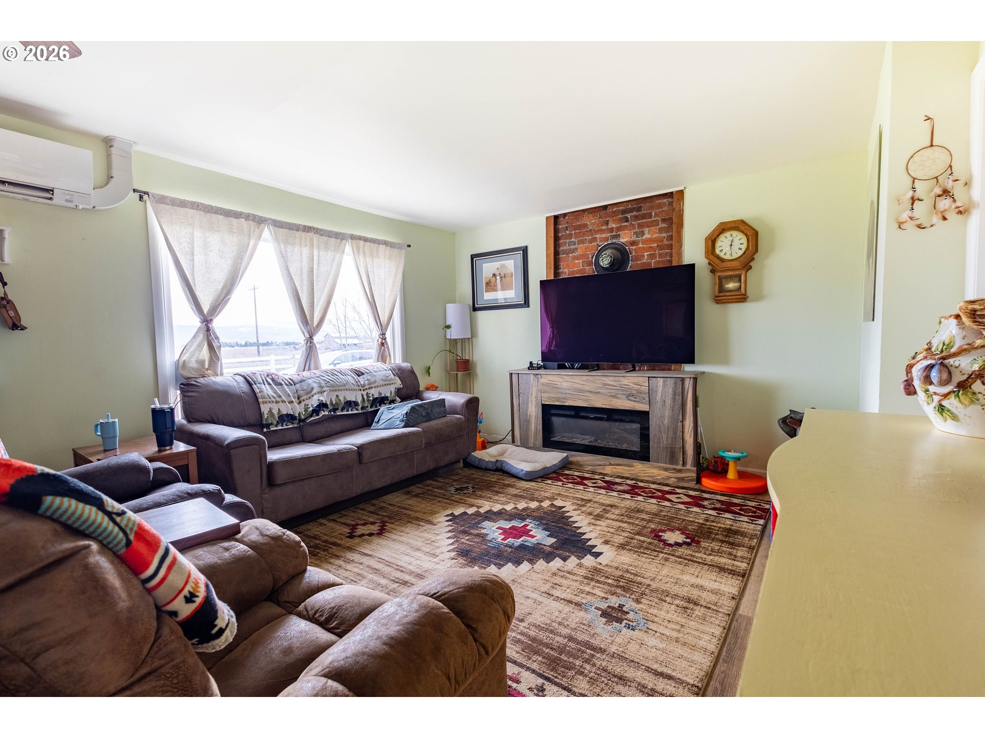 63150 Booth Lane La Grande, OR 97850 - Photo 4 of 29 a living room with furniture a fireplace and a flat screen tv