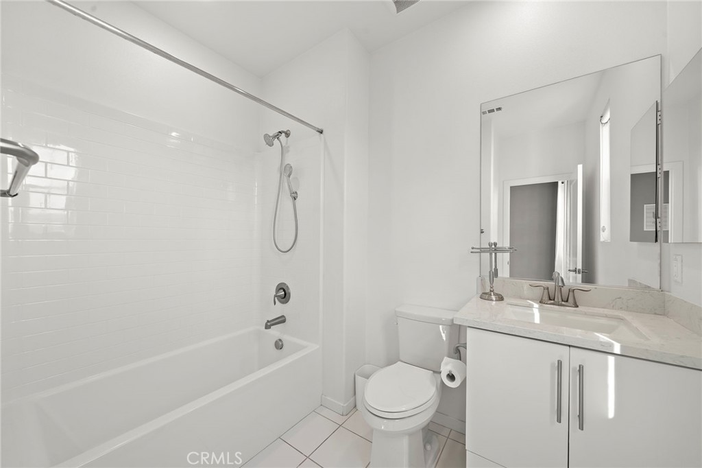 144 Paramount Irvine, CA 92618 - Photo 20 of 43 a bathroom with a granite countertop sink toilet and shower