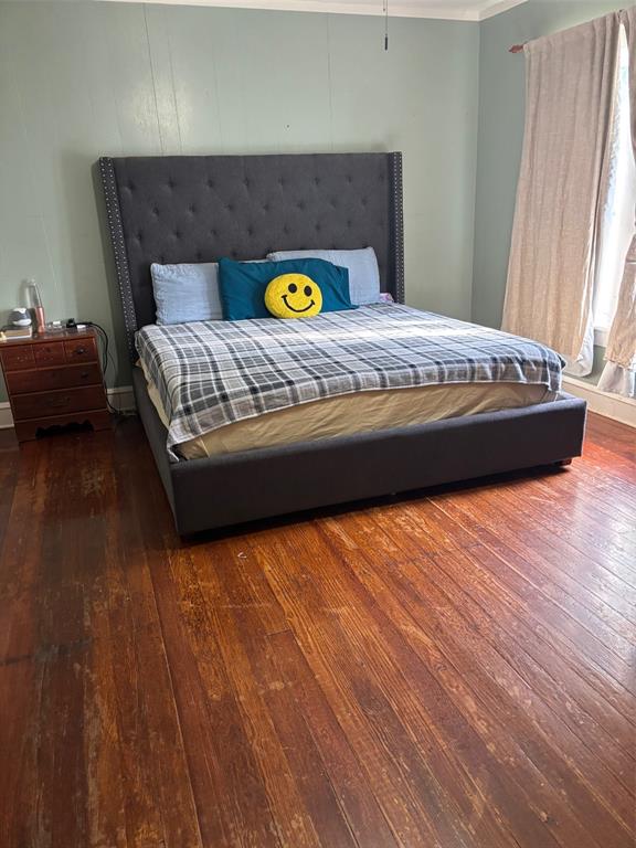 1528-1532 McFerrin Avenue Waco, TX 76708 - Photo 6 of 21 a bedroom with a bed and wooden floor