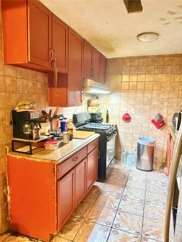 a kitchen with a sink cabinets and window