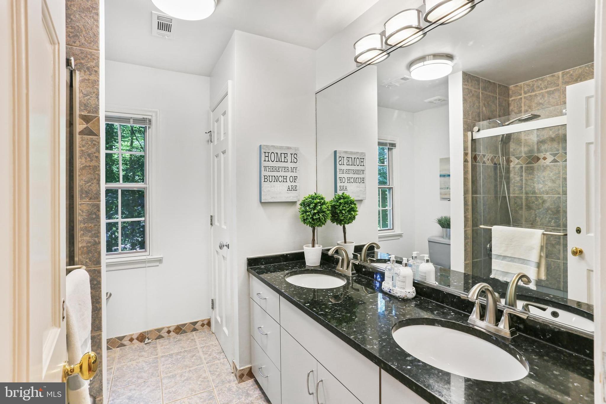 11843 Linden Chapel Road Clarksville, MD 21029 - Photo 49 of 128 a bathroom with a granite countertop sink a mirror and a shower