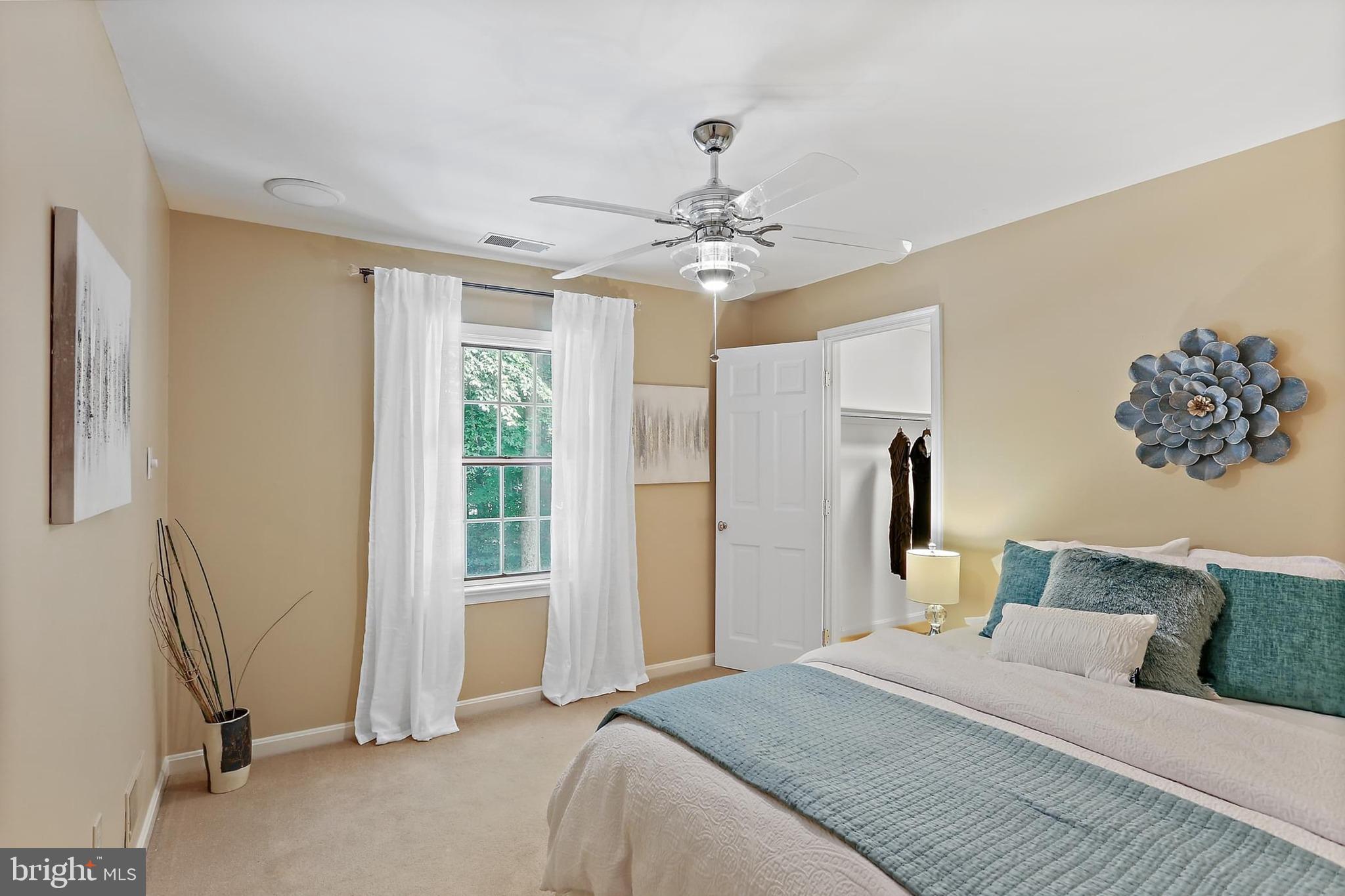 11843 Linden Chapel Road Clarksville, MD 21029 - Photo 63 of 128 a bedroom with a large bed and a chandelier