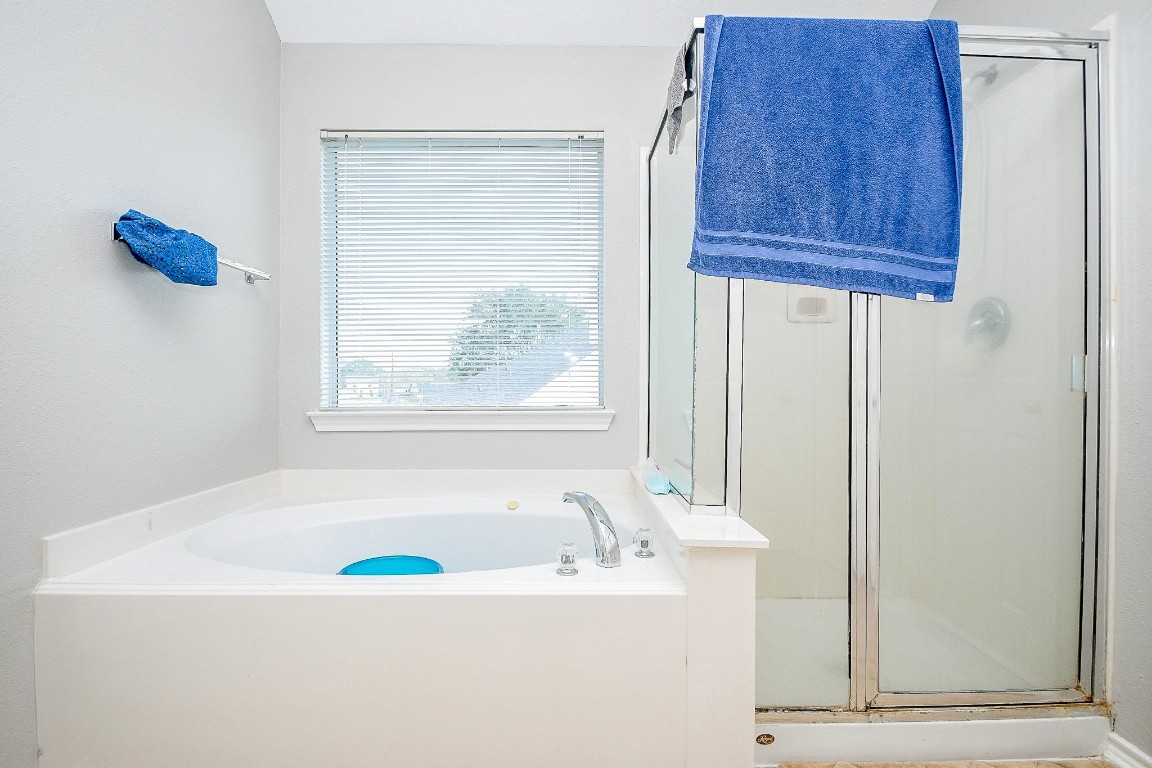 16402 Great Ridge Court Houston, TX 77083 - Photo 13 of 20 a bathroom with a tub and a window