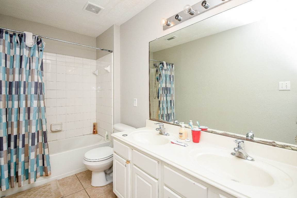 16402 Great Ridge Court Houston, TX 77083 - Photo 14 of 20 a bathroom with a sink a toilet and shower