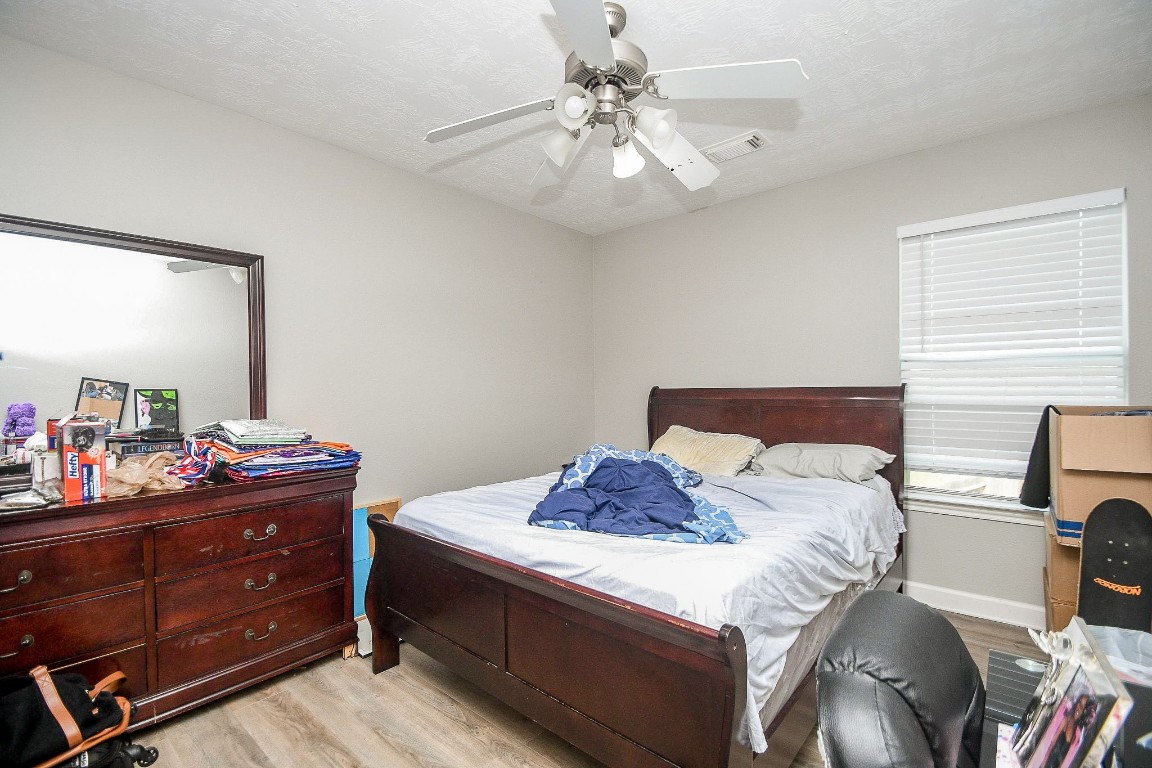 16402 Great Ridge Court Houston, TX 77083 - Photo 16 of 20 a bedroom with a bed and a dresser