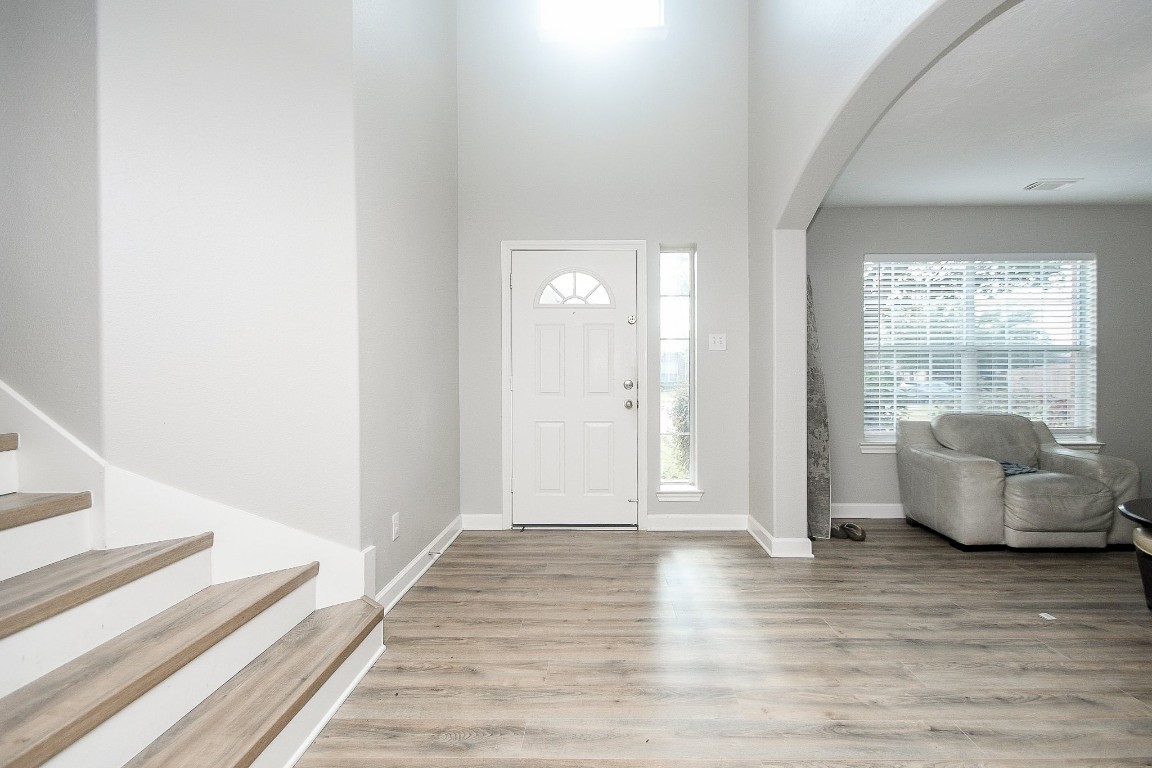 16402 Great Ridge Court Houston, TX 77083 - Photo 4 of 20 a view of a livingroom with wooden floor and couch