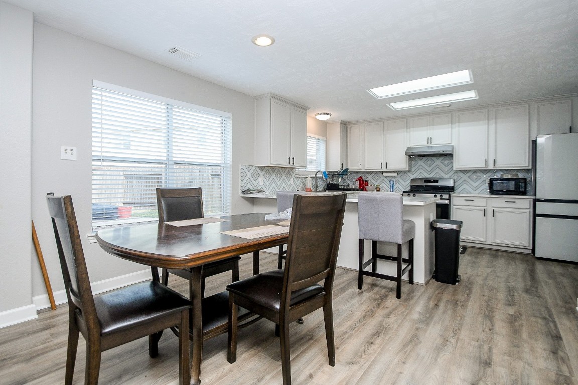 16402 Great Ridge Court Houston, TX 77083 - Photo 10 of 20 a view of a dining room with furniture and wooden floor