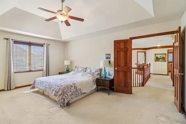 a bedroom with a bed and a chandelier