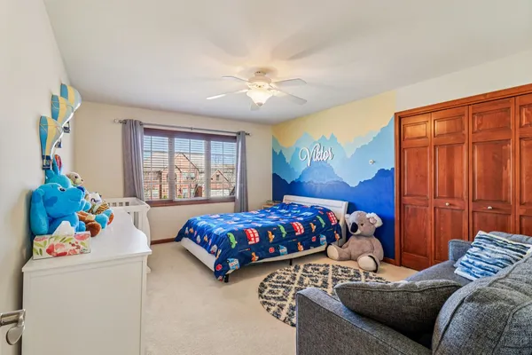 a bedroom with two beds and a window