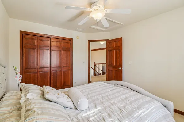 a bedroom with a large bed and a chandelier