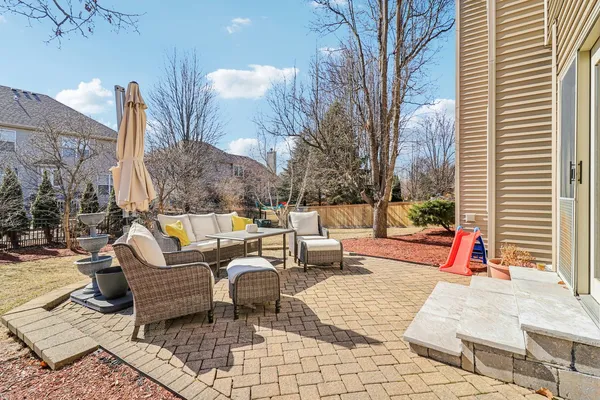 a backyard of a house with barbeque oven table and chairs