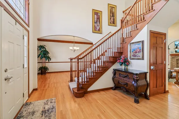 a view of entryway with wooden floor and stairs