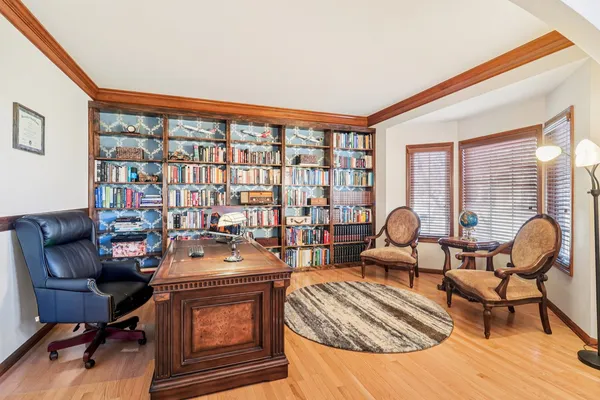 a work room with furniture and a floor to ceiling window
