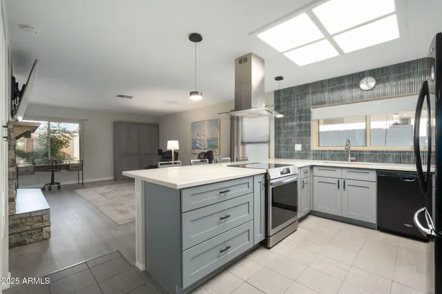 a kitchen with a stove a sink and a refrigerator