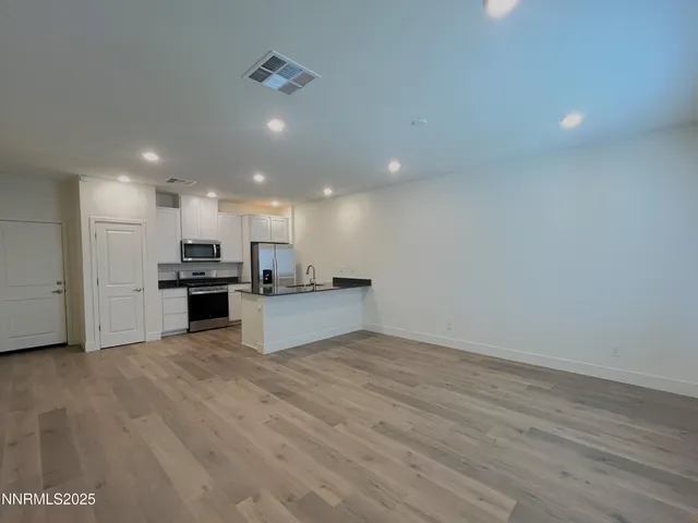 a view of kitchen with kitchen island sink and center island