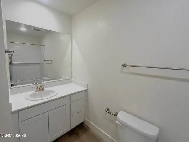 a bathroom with a sink a toilet and mirror