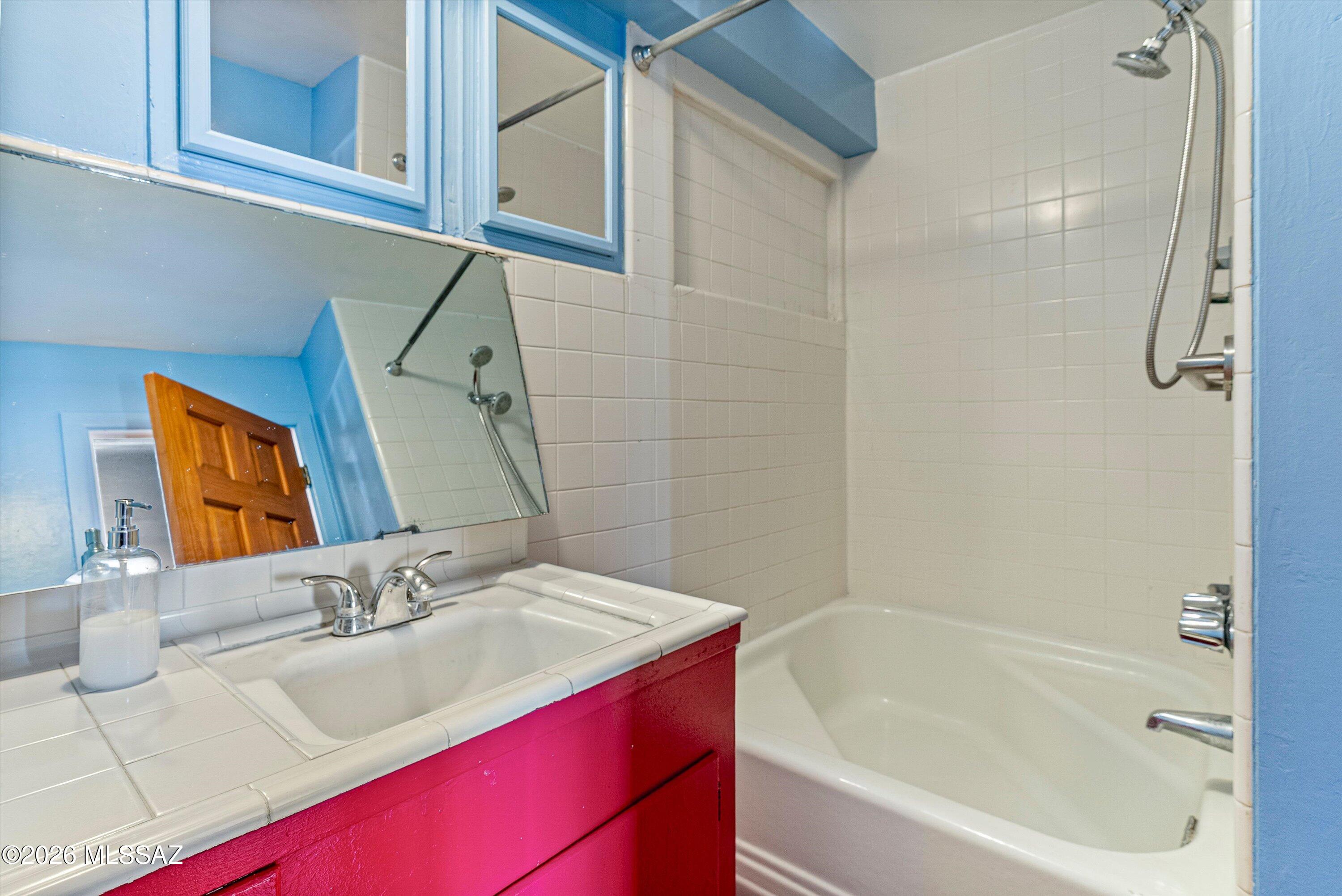 2107 East Lind Road Tucson, AZ 85719 - Photo 22 of 43 a bathroom with a sink vanity tub and shower